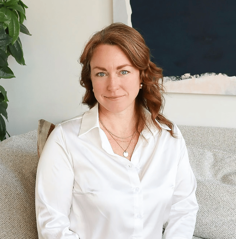 Melissa Speight seated on a sofa in a white blouse.