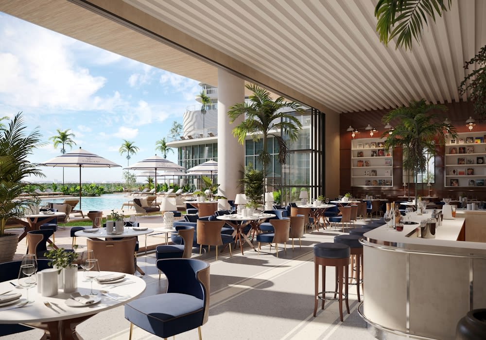 Open-air restaurant terrace with white-set tables, blue chairs, palm trees, and a poolside view.