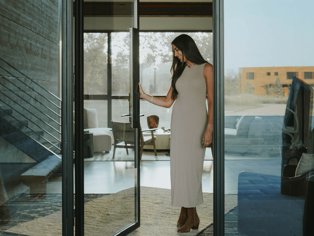 Amelia Turbyfill in a doorway of a luxury home