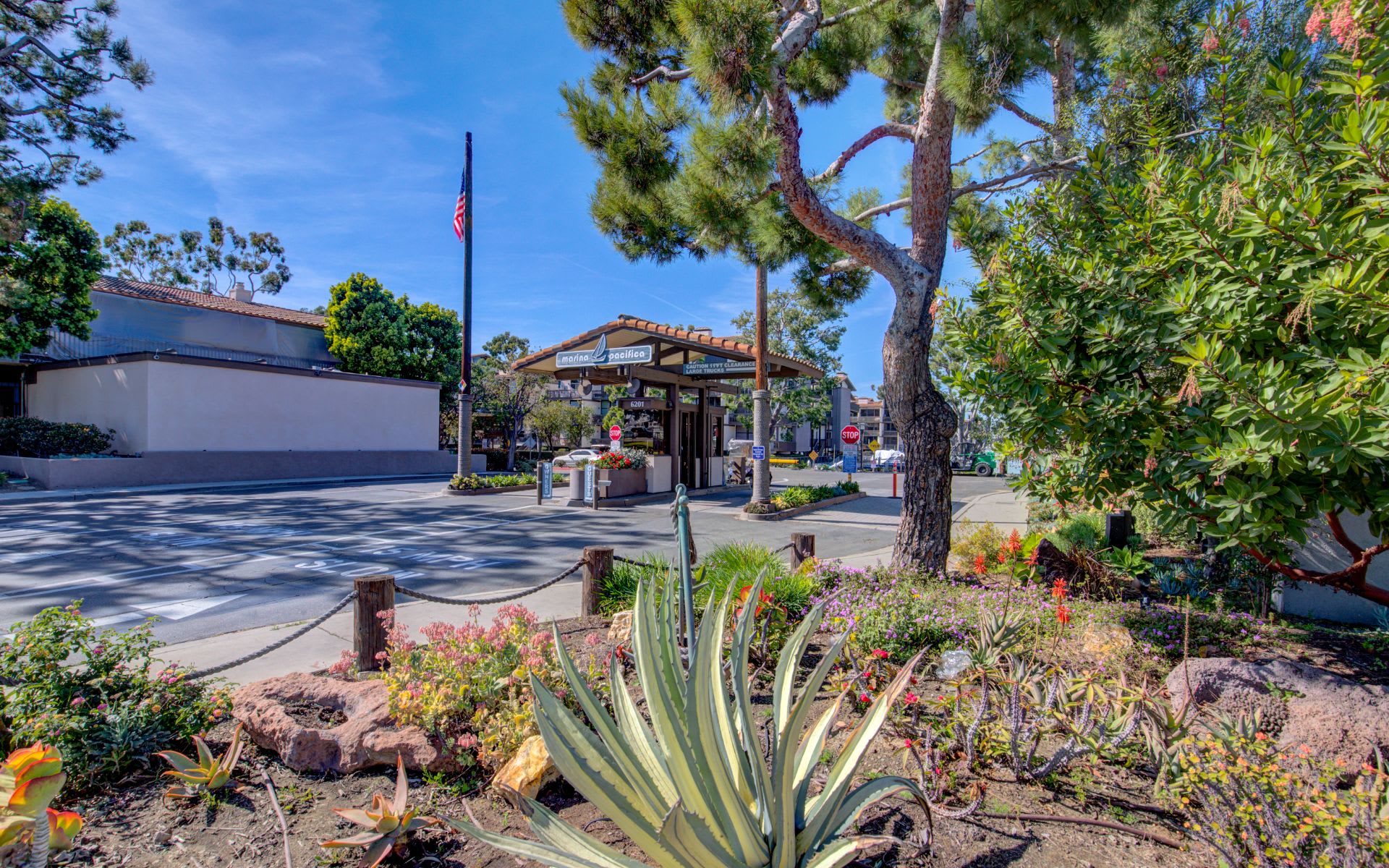 Marina Pacifica community entrance with a tiled-roof gate and landscaped grounds.