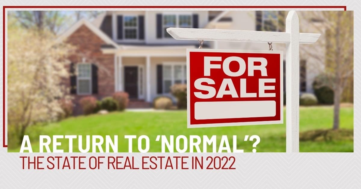 A Return to Normal. The state of Real Estate in 2022. For Sale Sign in the foreground in front of a traditional style home