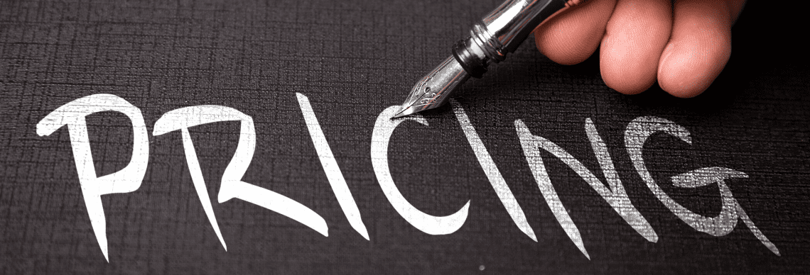 "PRICING" being written with a fountain pen on a textured black surface, conveying themes of cost evaluation and financial decision-making. 