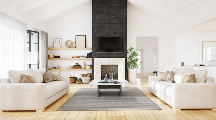 Living room with facing white sofas, a dark stone fireplace wall, and light wood floors.