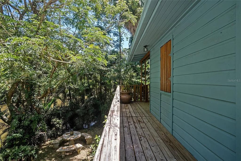 Wooden balcony overlooking lush green forest