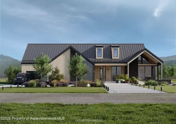 Modern home with a dark metal roof, glazed entry, broad steps, and landscaped front lawn.
