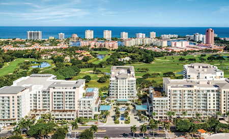 Aerial view of East Boca Raton condos, landscaped grounds, and the Atlantic Ocean.