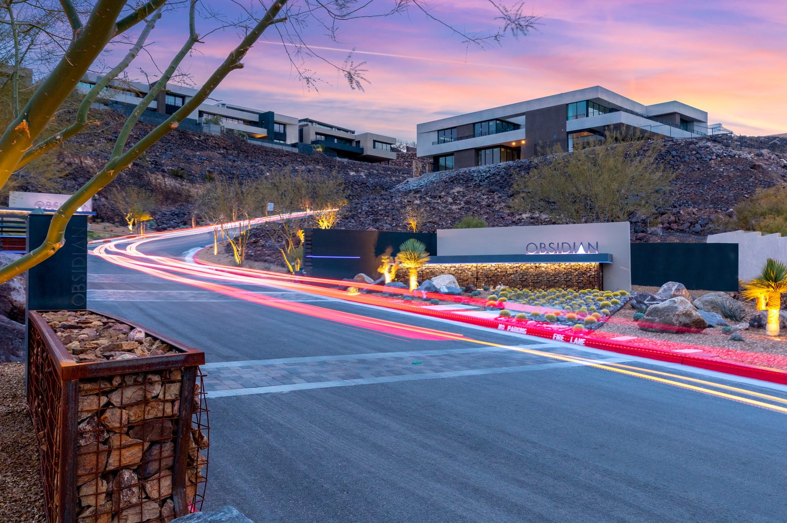 Road and hillside homes in Obsidian at dusk