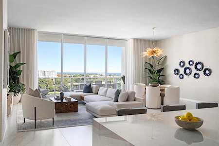 Modern living room with floor-to-ceiling windows and a water view.
