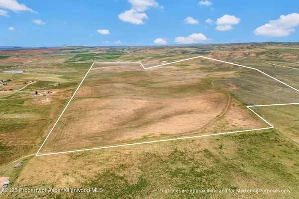 Aerial view of an undeveloped Craig parcel outlined in white across dry, rolling terrain.