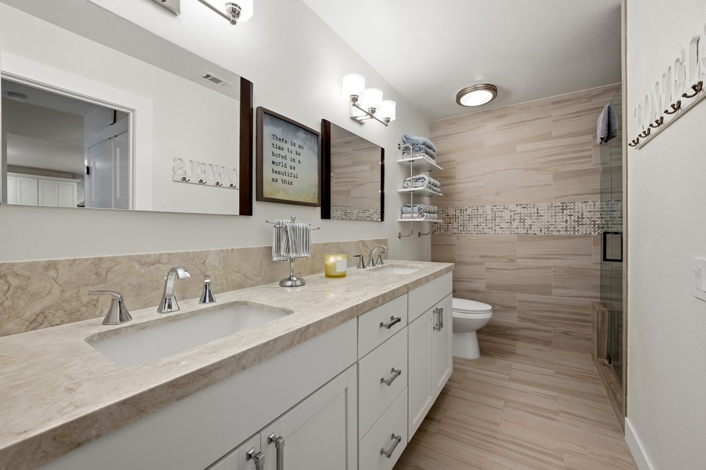 Guest bathroom with double vanity and tiled walk-in shower at a PGA West home