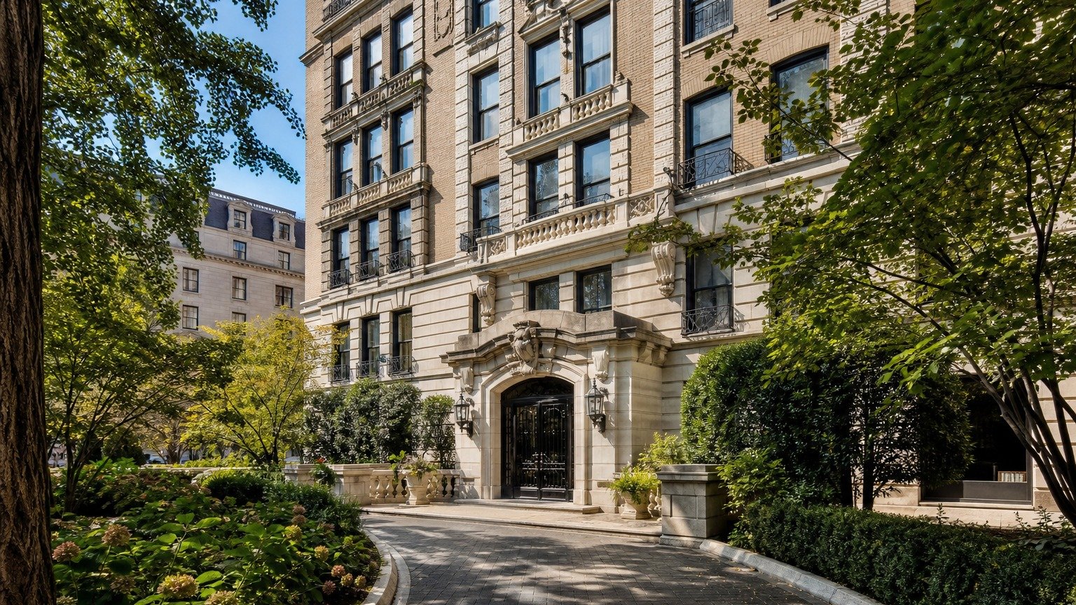 Prewar-style apartment building with an ornate arched entrance and leafy landscaped grounds.