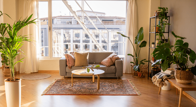 A cozy living room featuring a comfortable couch, a stylish table, and a soft rug on the floor.