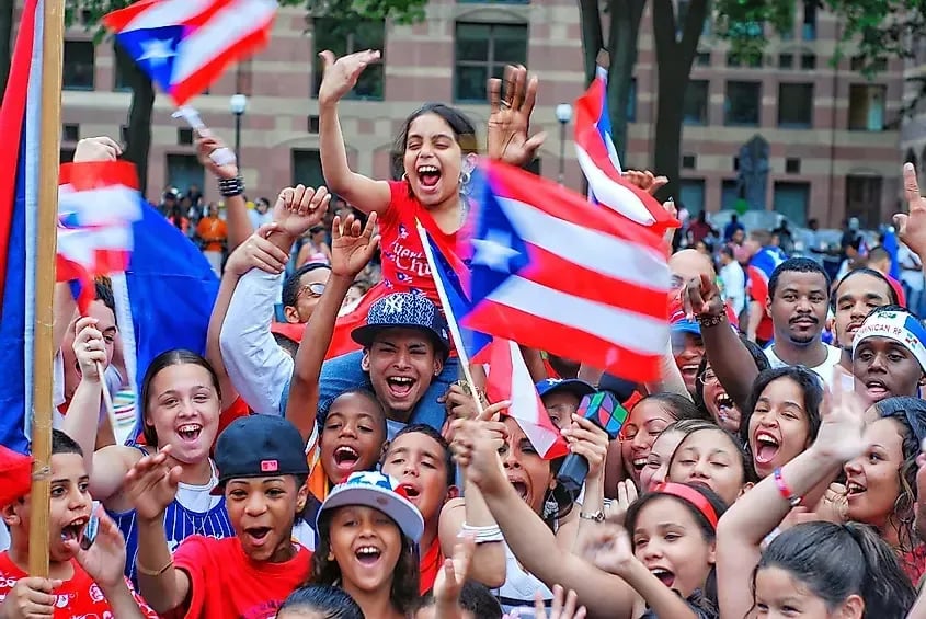 a crowd of children waving Puerto Rico flags 