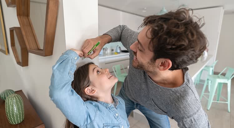 A cheerful interaction between a parent and child, showing warmth and care. The parent is engaging playfully with the child, creating a joyful and loving scene.