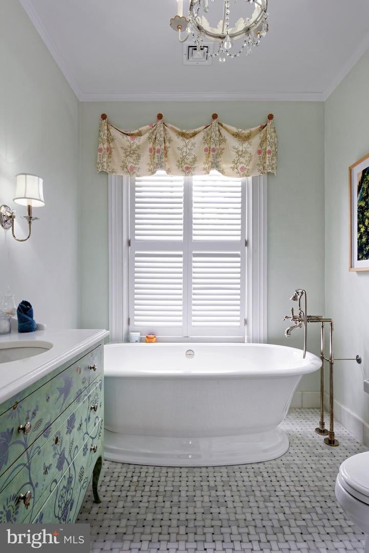Bathroom with a freestanding tub, shuttered window, floral valance, and painted green vanity.