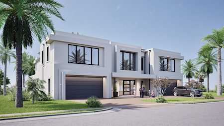 Modern two-story white home with a broad garage and palm trees along the street.