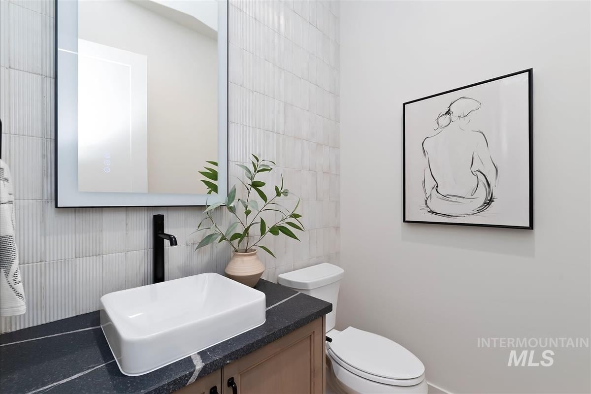 Powder room with modern rustic white tile wall, leather granite counter and abstract art on the wall