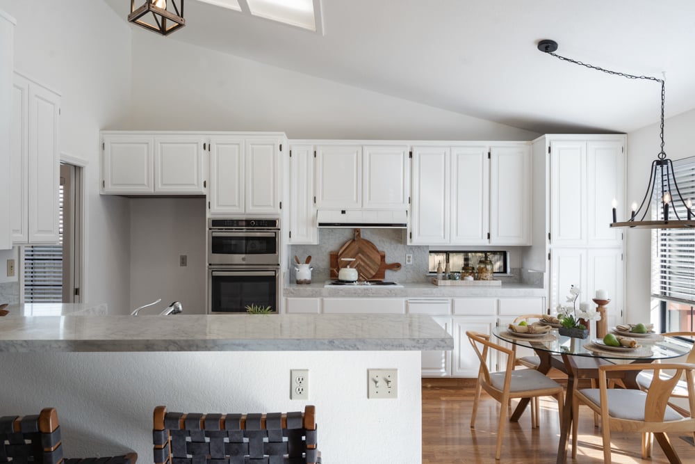 Kitchen with seated breakfast bar and open flow to living space in Petaluma home