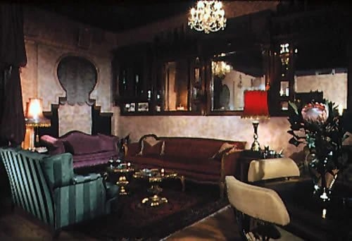 Club Lua lounge with sofas, armchairs, low tables, and chandeliers.