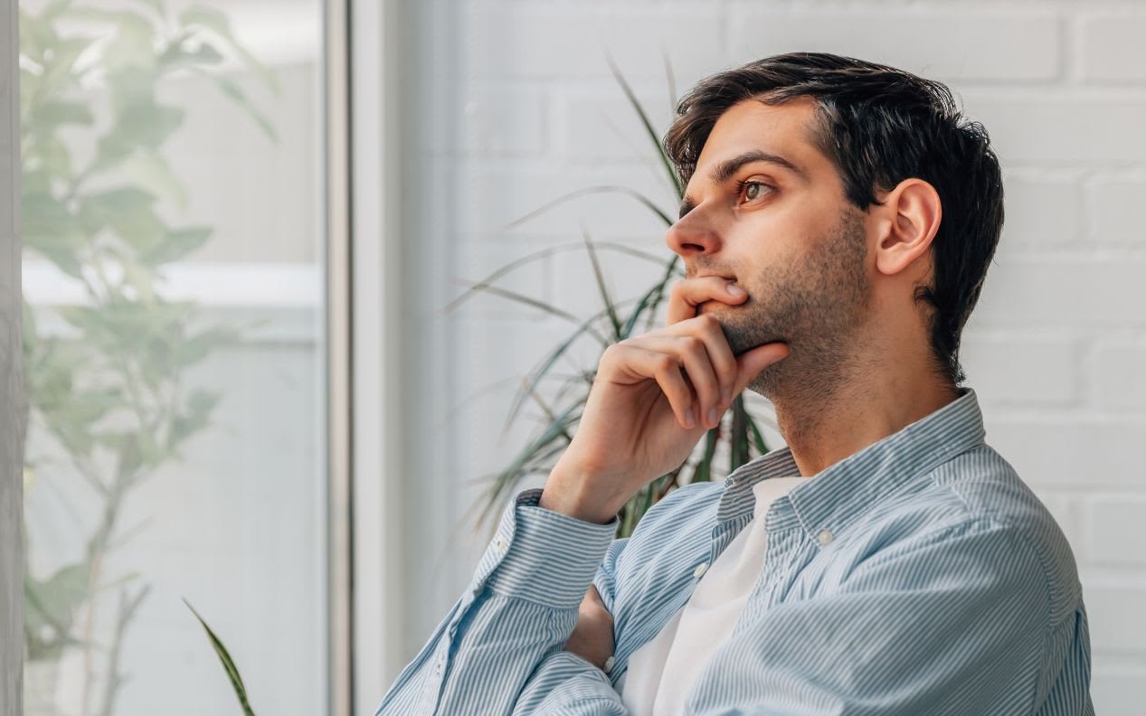 thoughtful young man with decision making gesture