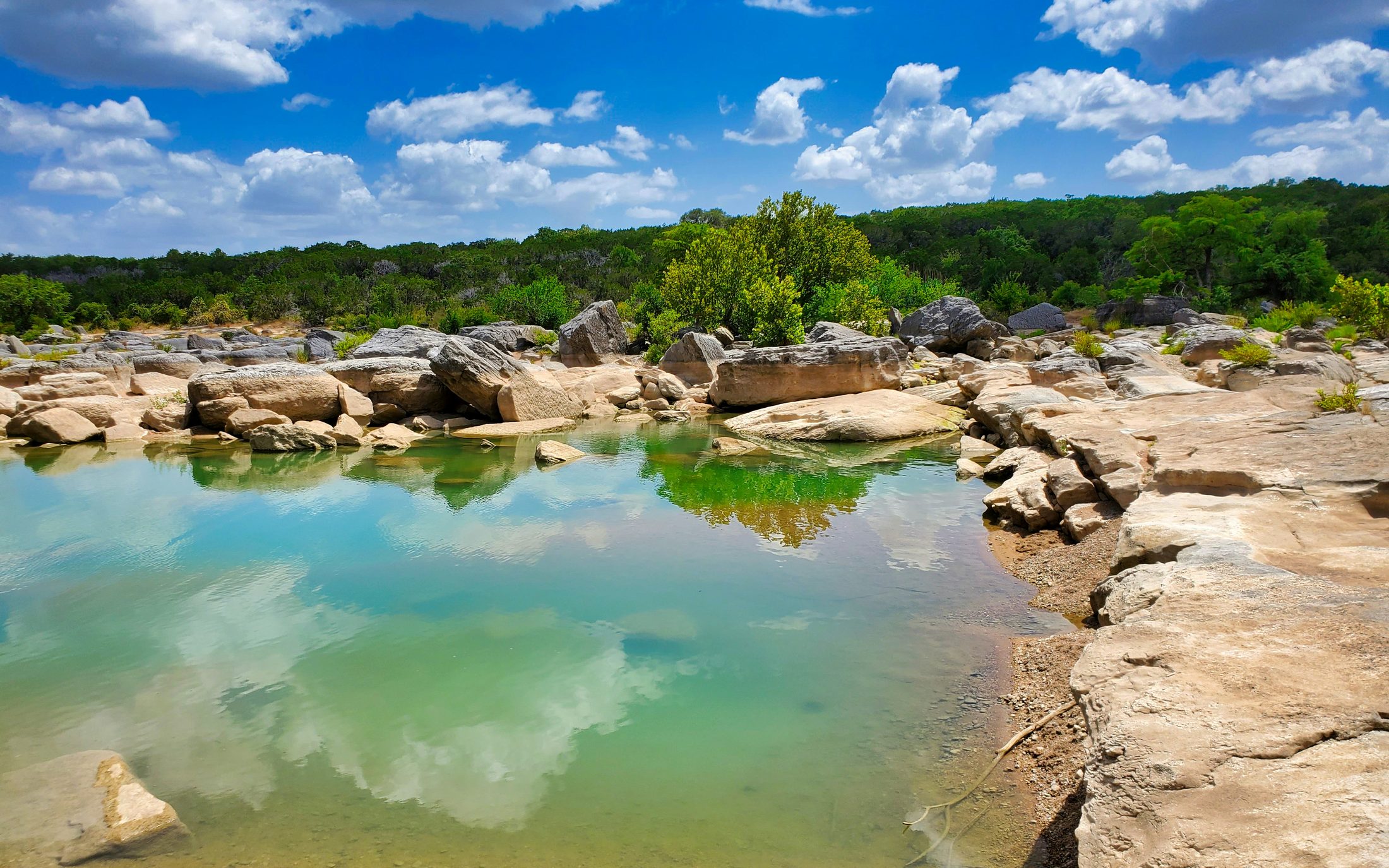 Limestone shelves and clear water at Pedernales Falls State Park near Johnson City, Texas.