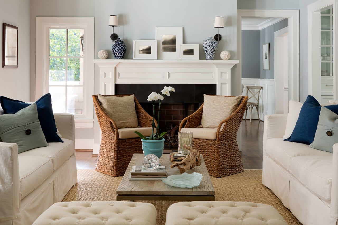 Elegantly appointed living room in a luxury home with a cozy fireplace, neutral tones, and tasteful decor.