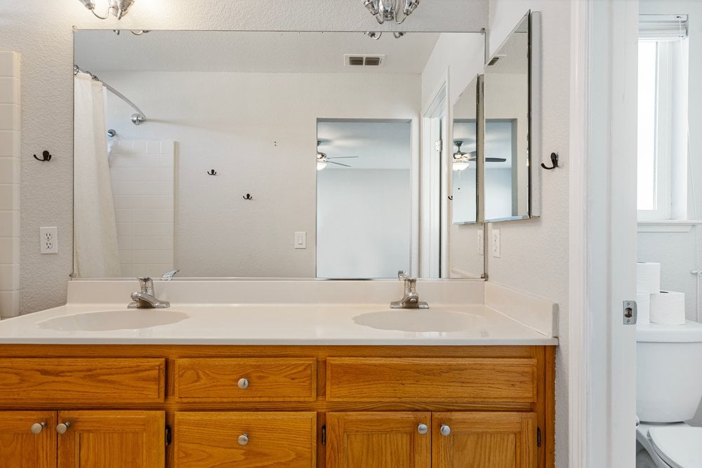 En suite bathroom with double-sink vanity and clean finishes