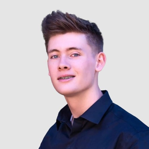 Jordan Smith in a dark collared shirt, with short styled hair and braces.