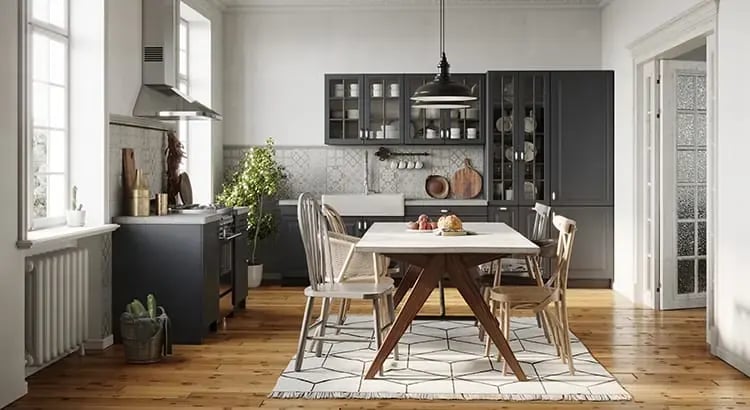 A dining area with a modern, minimalist design. It features a wooden table, several chairs, a hanging light fixture, and large windows allowing natural light to enter the space.