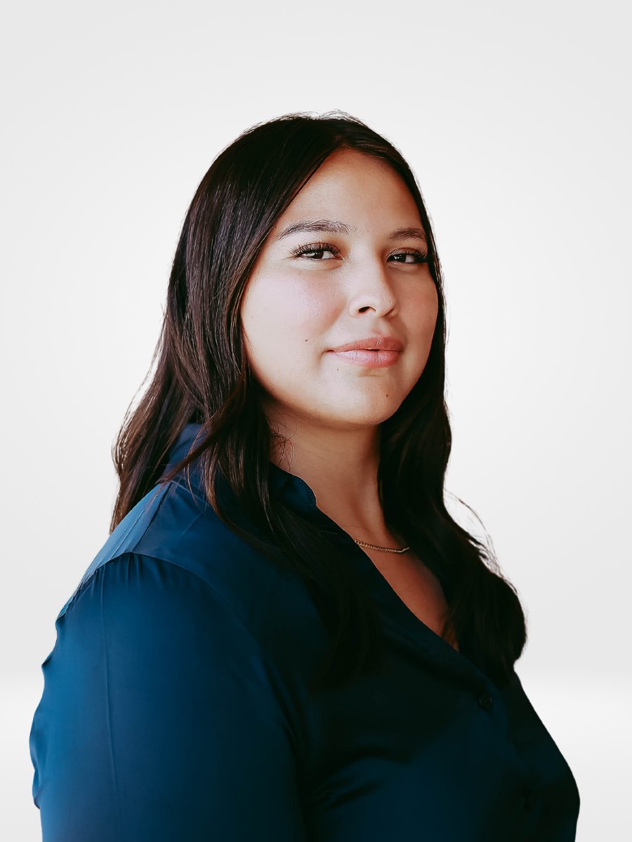 Janery Sanchez in a navy blouse, photographed against a light background.