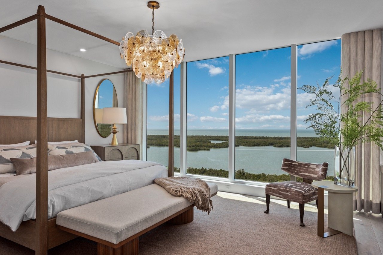 Master bedroom with floor-to-ceiling windows overlooking the water at Kalea Bay