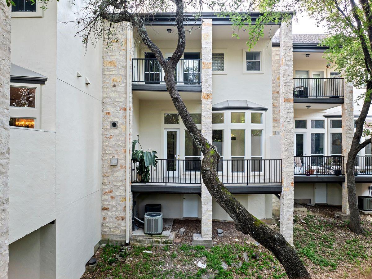 Rear elevation with private balconies among oak trees, Barton Hollow, Westlake, Austin.