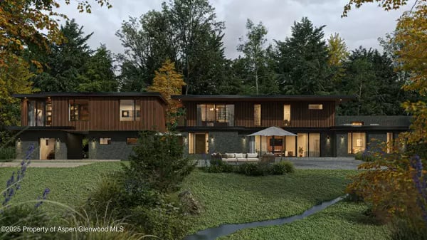Modern two-story home with dark stone and wood siding, expansive windows, and a landscaped lawn.