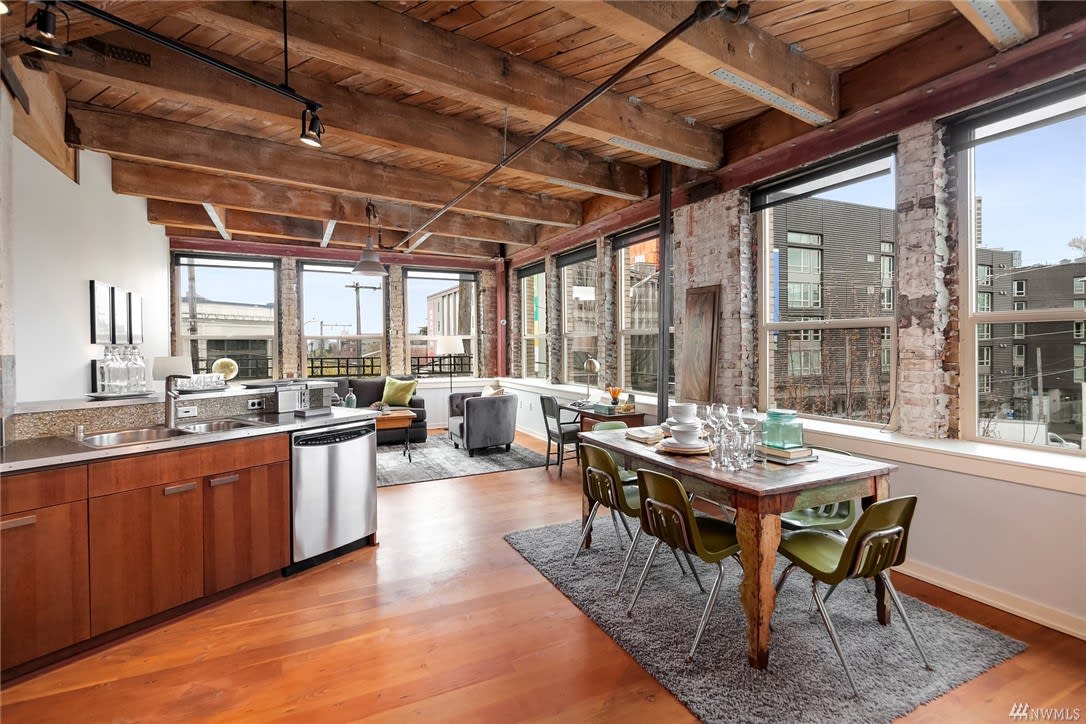 A luxurious kitchen and dining area in a loft apartment featuring contemporary design and high-end finishes.