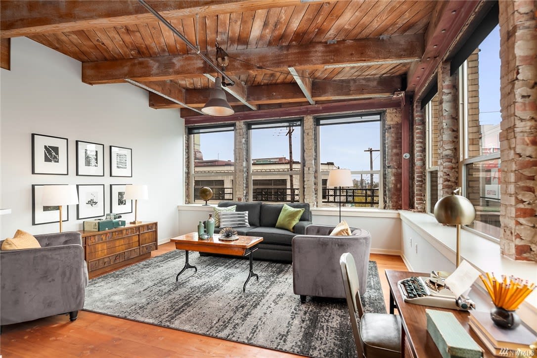 A cozy living room with a plush couch, elegant chair, and stylish table.