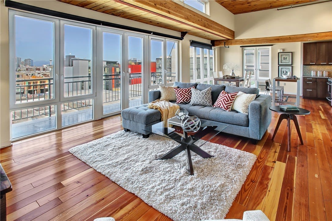 Luxury living room with wood floors showcasing a breathtaking city view.