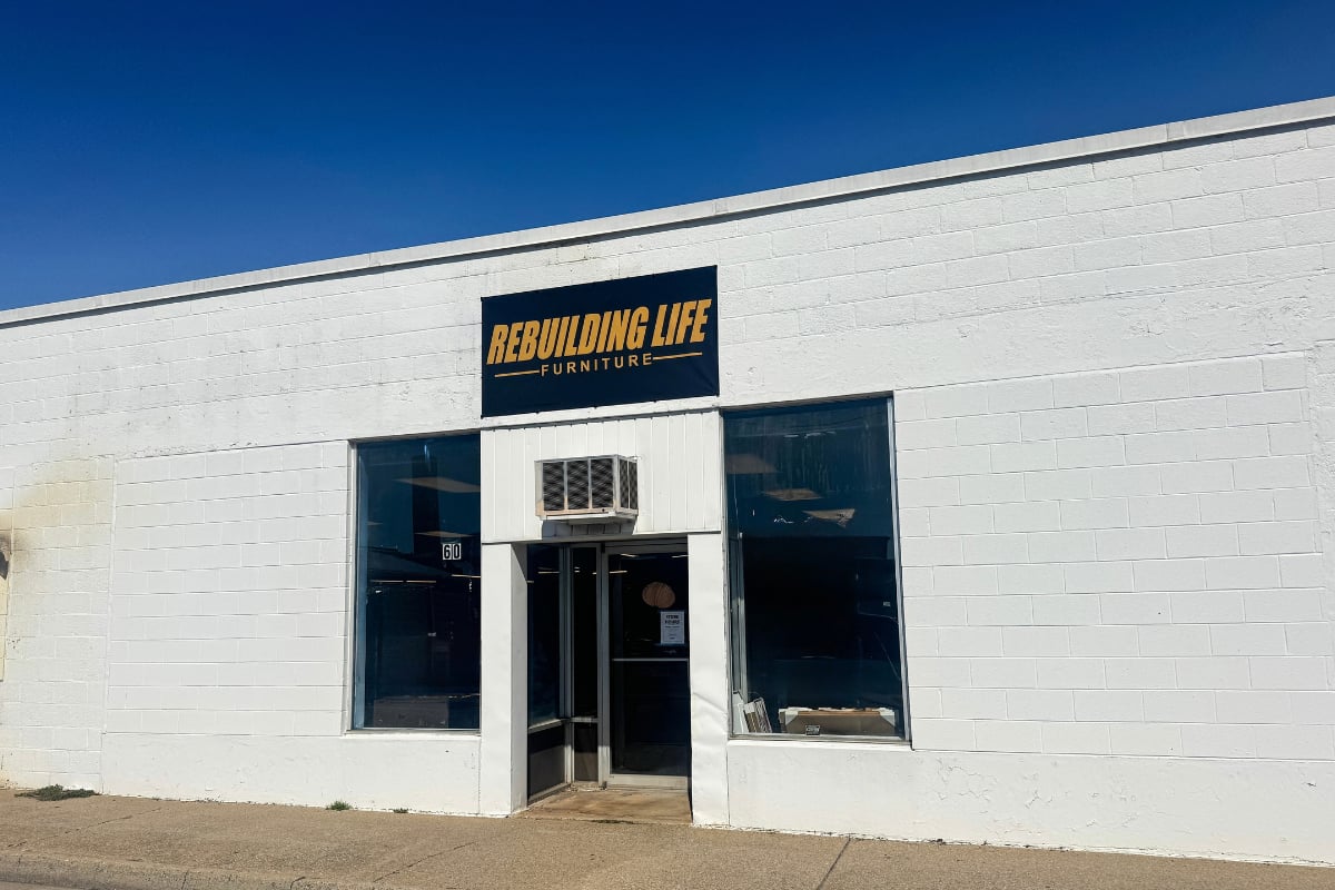 Rebuilding Life Furniture storefront with a white facade and dark glass entrance.