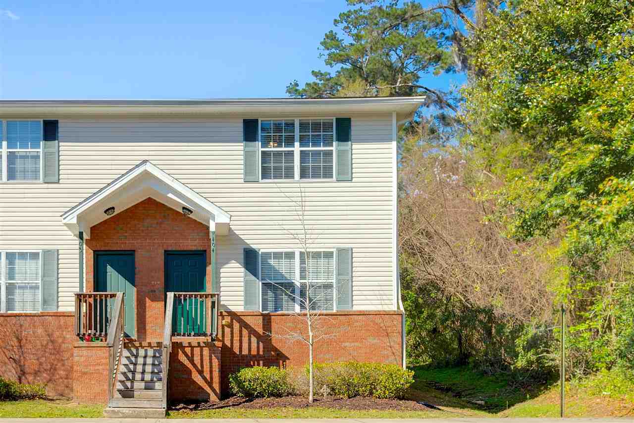 A two-story apartment building with a welcoming entrance and well-maintained exterior.