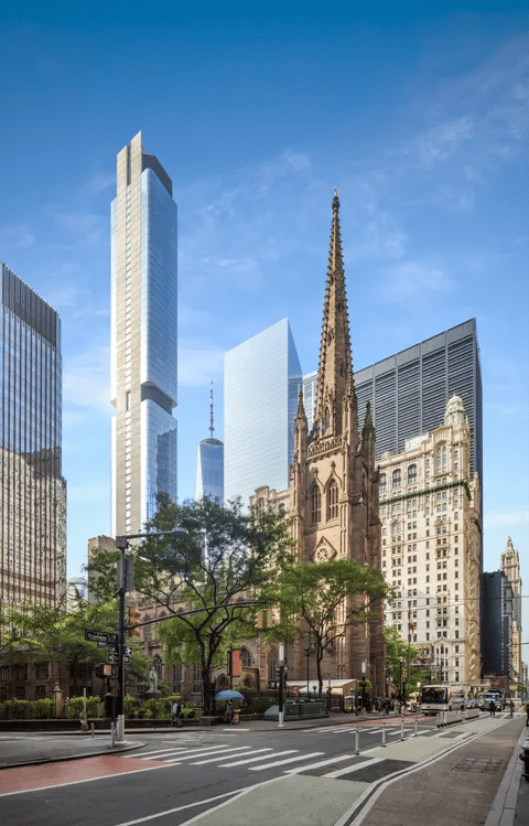Manhattan streetscape with a Gothic church spire among modern skyscrapers.