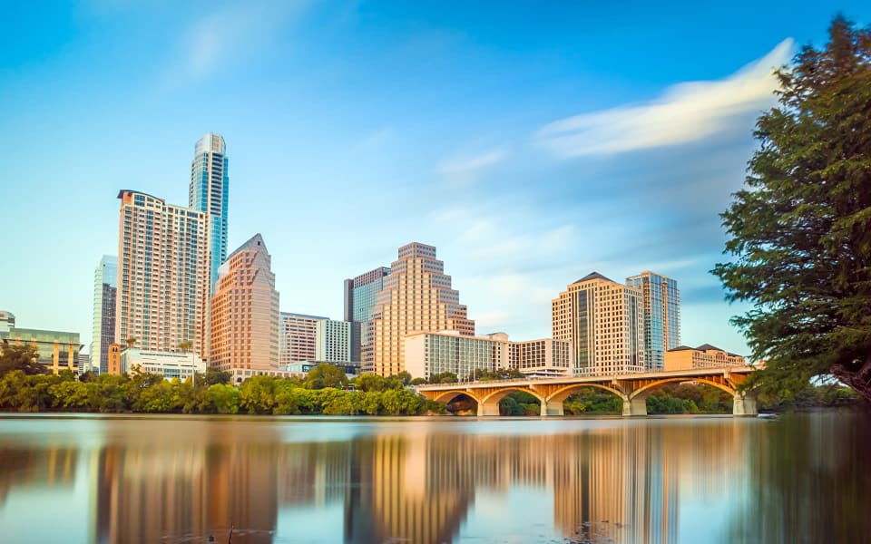 Photo of Tall Buildings and It's Shadow by the Lake 