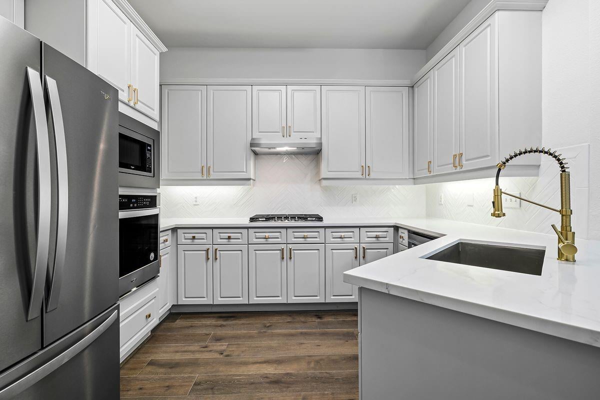 Kitchen with stainless appliances and quartz counters, Barton Hollow, Westlake, Austin.