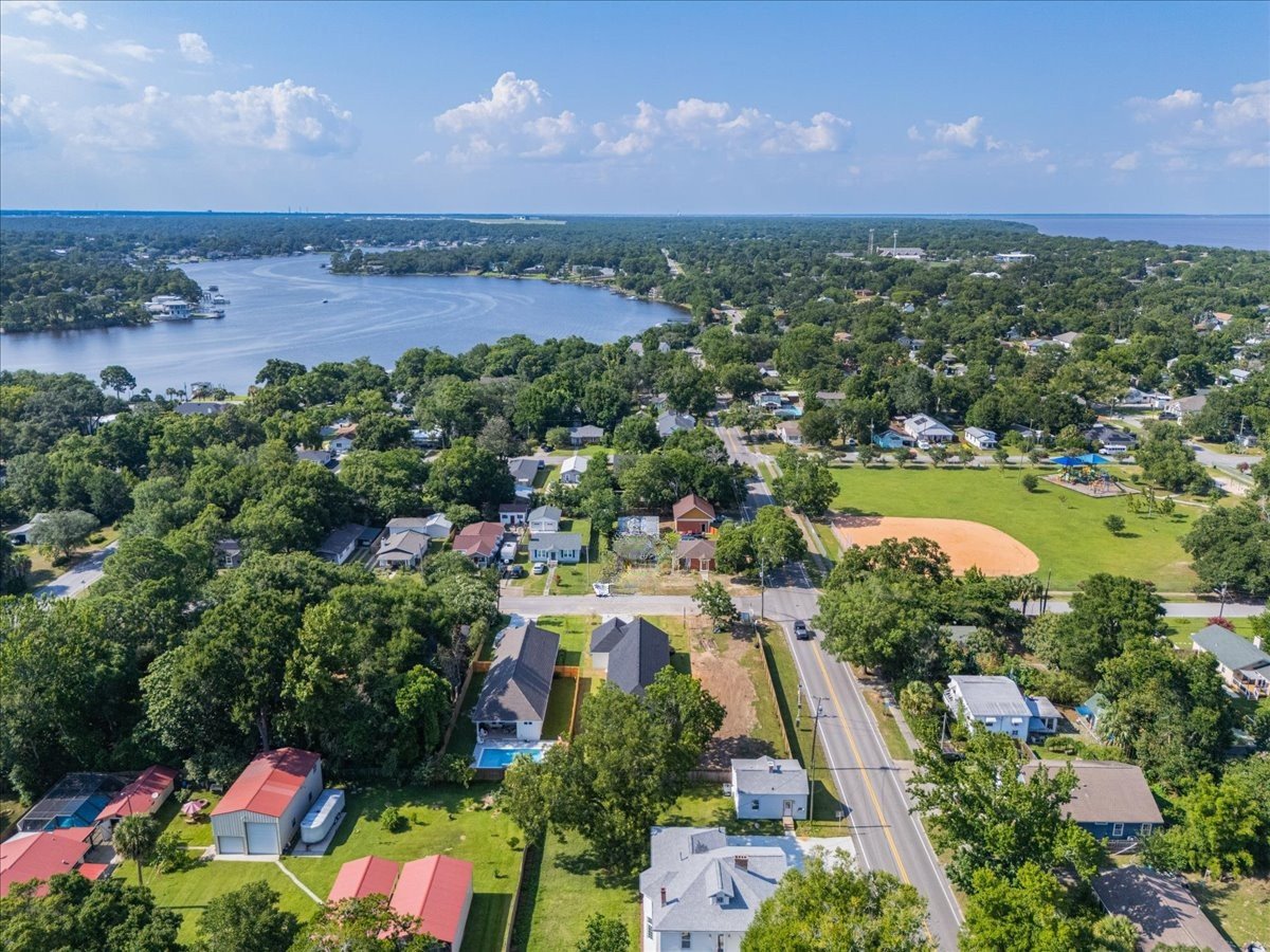 Aerial view of East Pensacola Heights homes beside a winding bayou, with a park in the foreground.