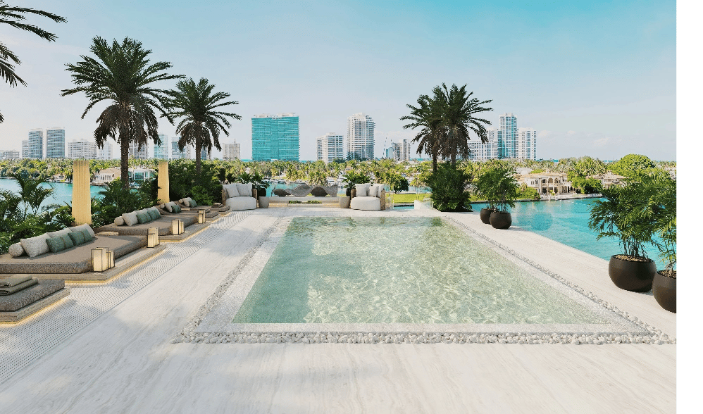 Rooftop pool terrace overlooking waterfront and city skyline, with palm trees and built-in lounge seating.
