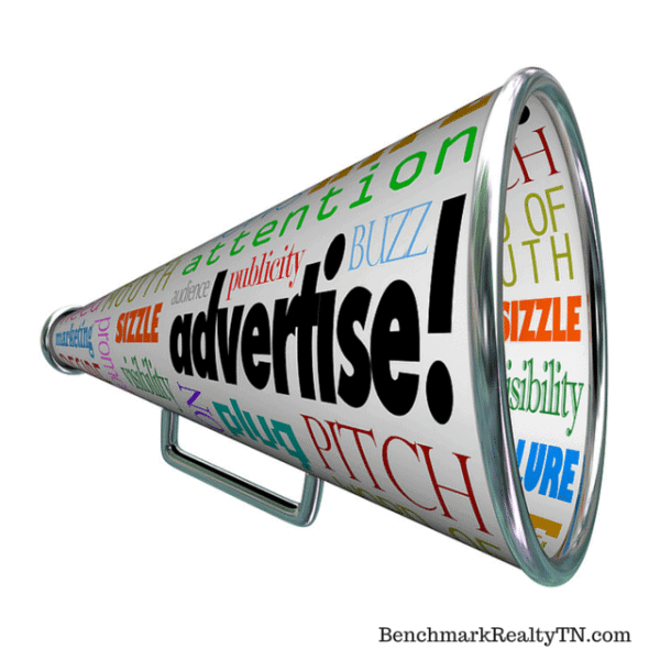 Megaphone covered with advertising-related words, including “advertise,” with BenchmarkRealtyTN.com beneath it.