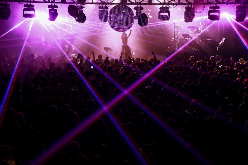 Crowd dancing at an intimate electronic music event in a San Francisco warehouse space