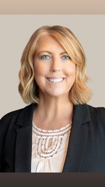 Brooke Gillum, smiling in a black blazer and white blouse.