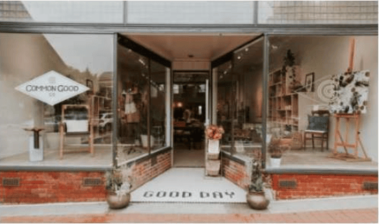 Common Good shop entrance with glass storefront and a GOOD DAY doormat.