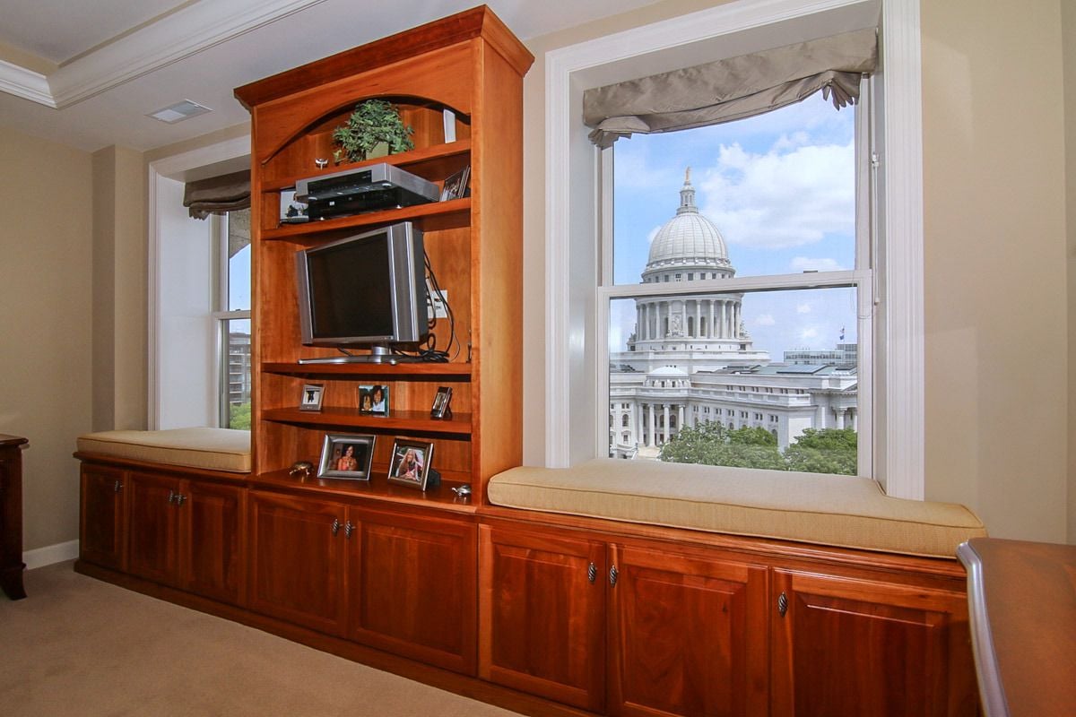 Penthouse media cabinetry and window seat overlooking the Wisconsin State Capitol.