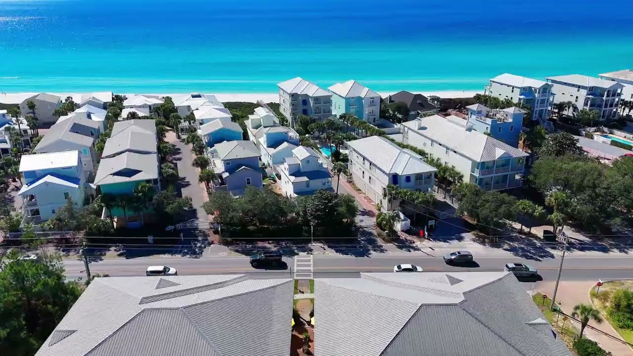 Aerial view of coastal homes beside turquoise Gulf waters in Santa Rosa Beach.