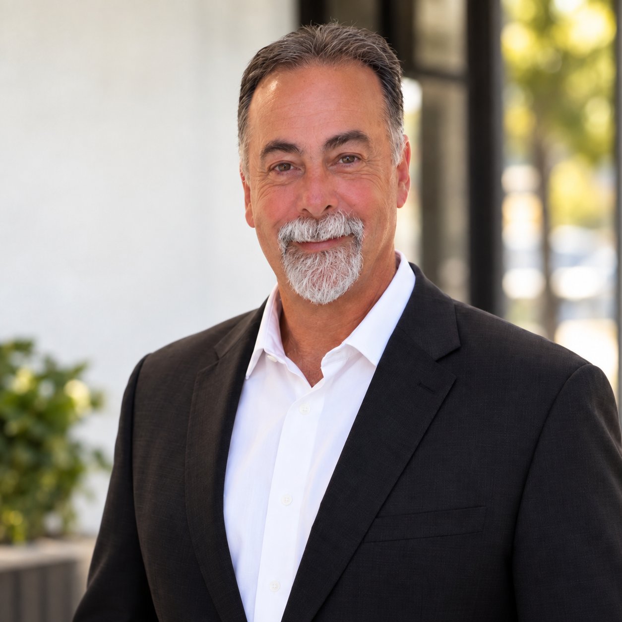 Charles Revel in a dark suit and white shirt.
